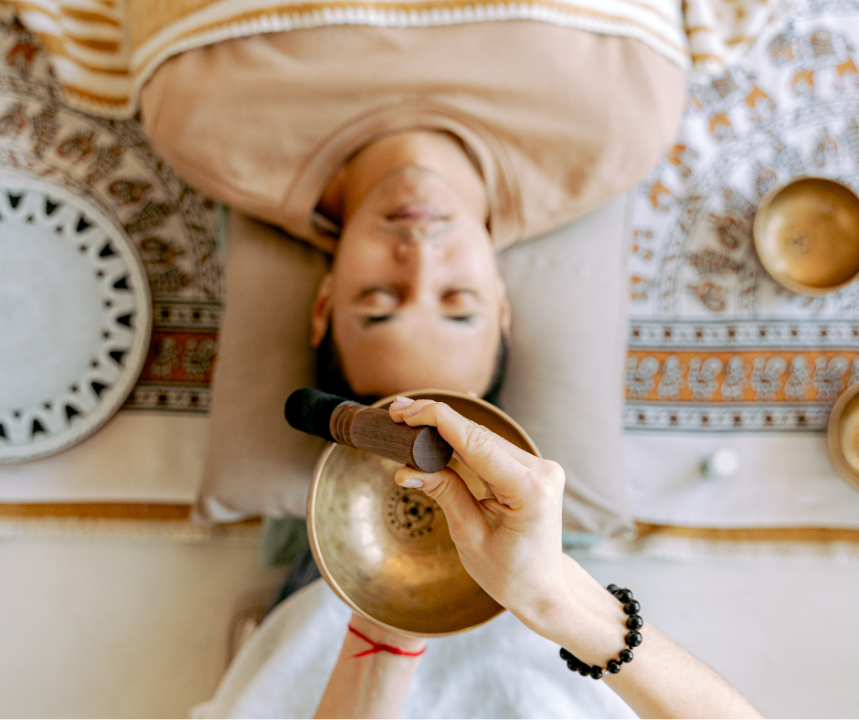 sound bath being performed with singing bowl