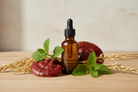 a brown glass dropper bottle surrounded by red reishi, lemon balm and oatstraw