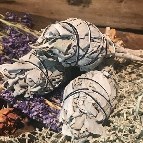 group of three wrapped bundles of sage ready for cleansing and smudging