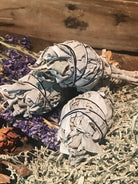 group of three wrapped bundles of sage ready for cleansing and smudging